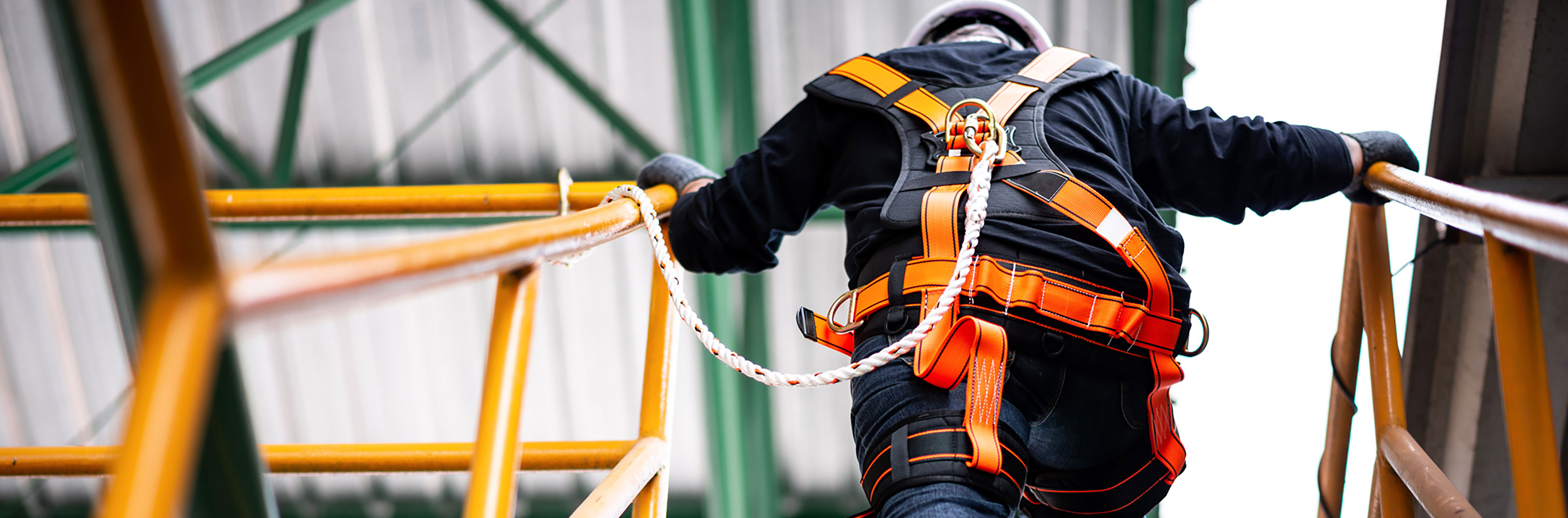 Ĵý construction worker wearing safety harness and safety line working at a high location
