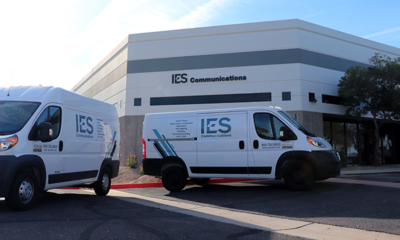 Ĵý Commercial building with Ĵý electrical and communications services van by the entrance